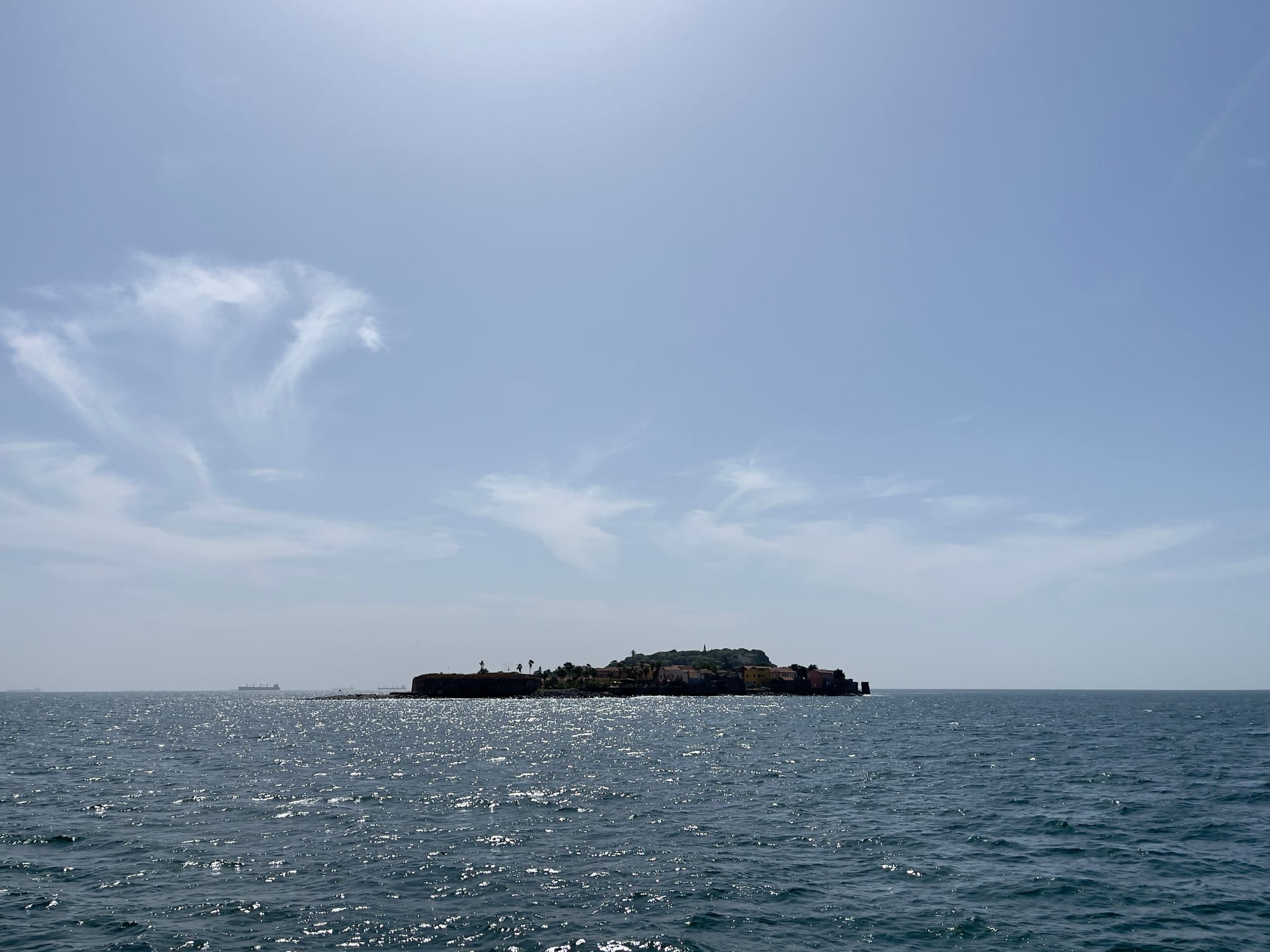 A small island with colonial-era buildings seen from the water