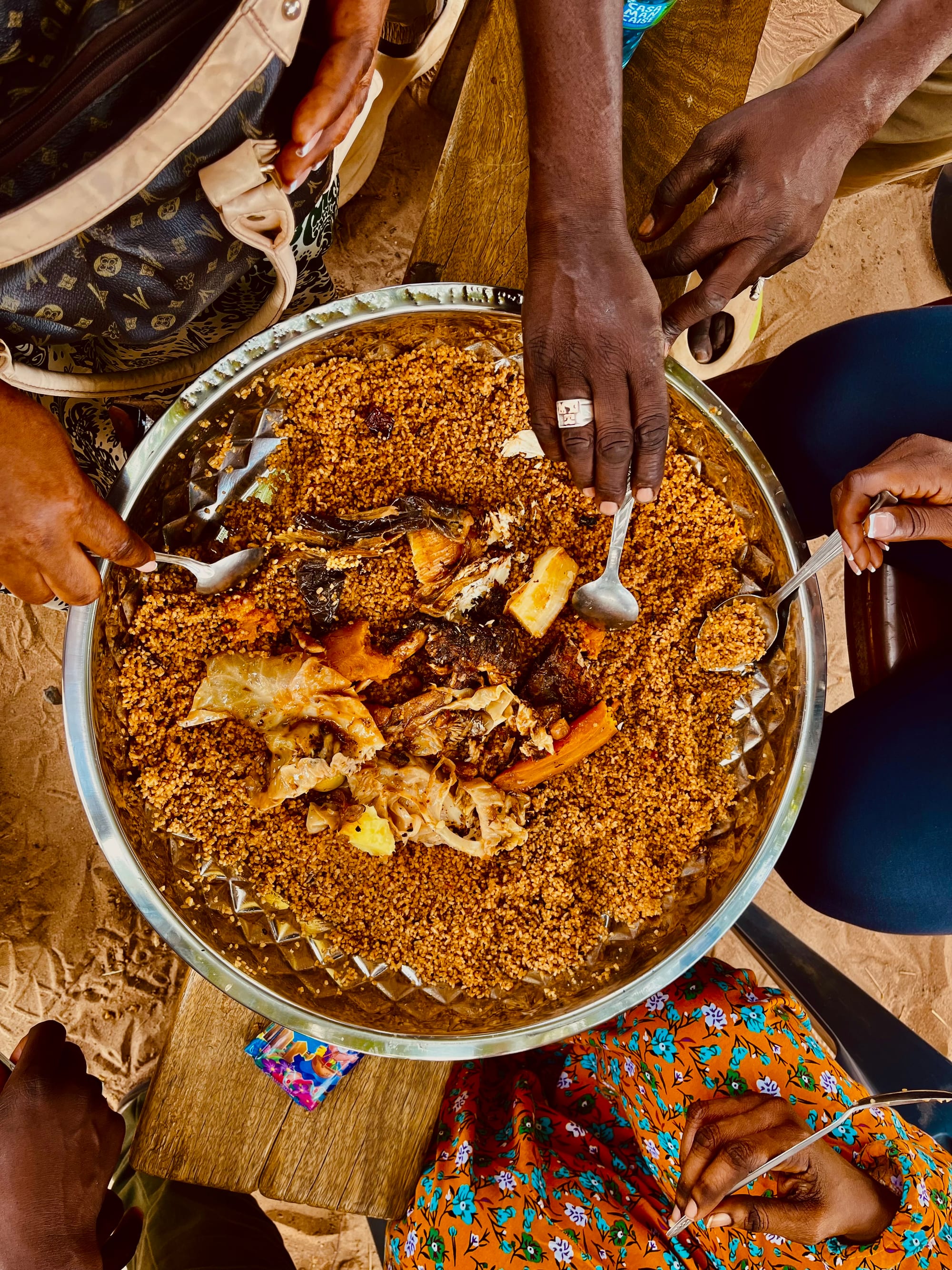 People sharing a meal of rice and fish from a communal platter