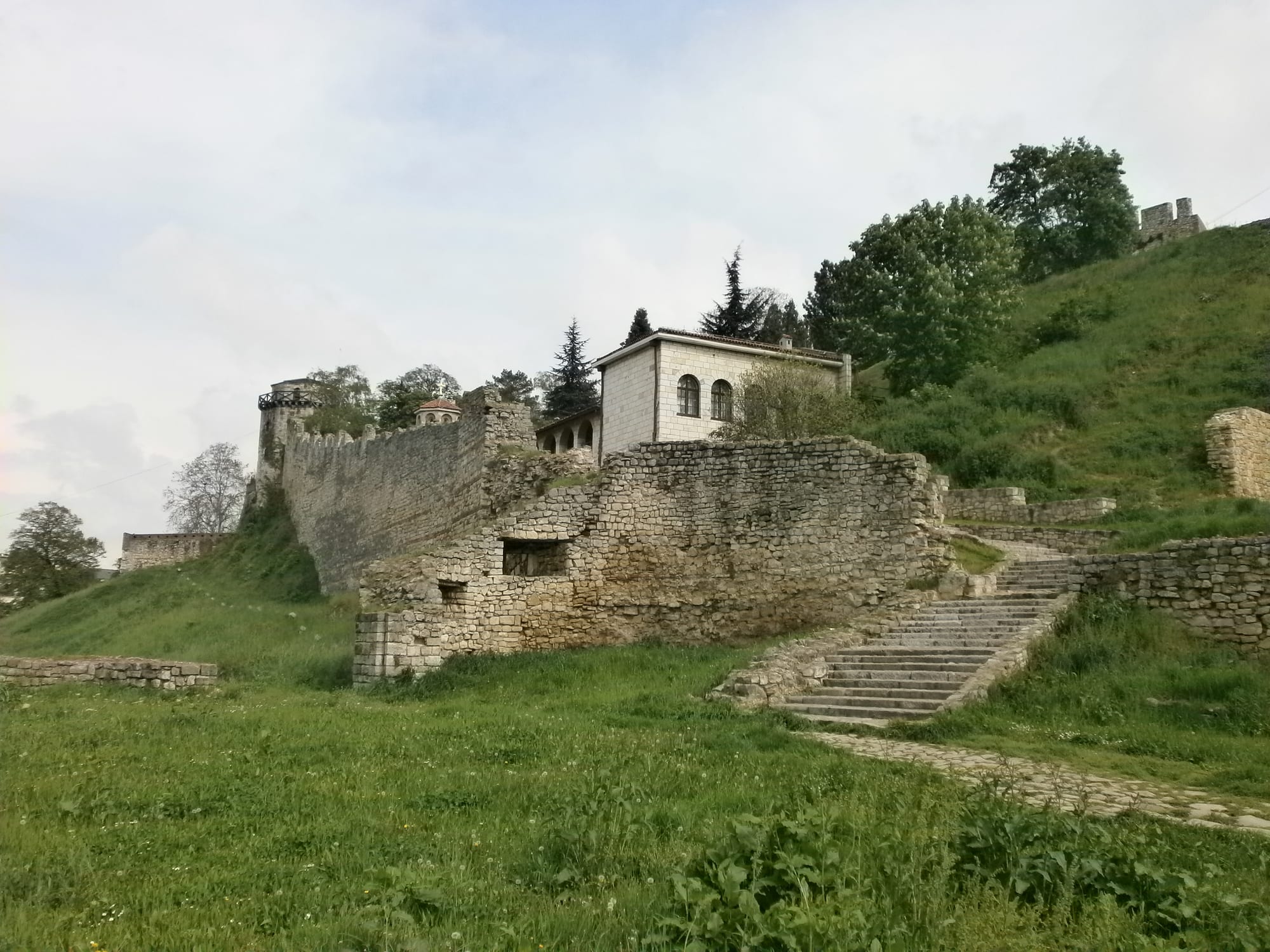 A stone fortress park overlooking a wide river confluence