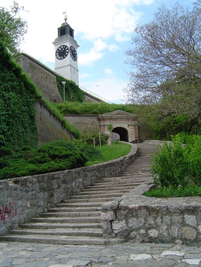 A large hilltop fortress overlooking a river and city