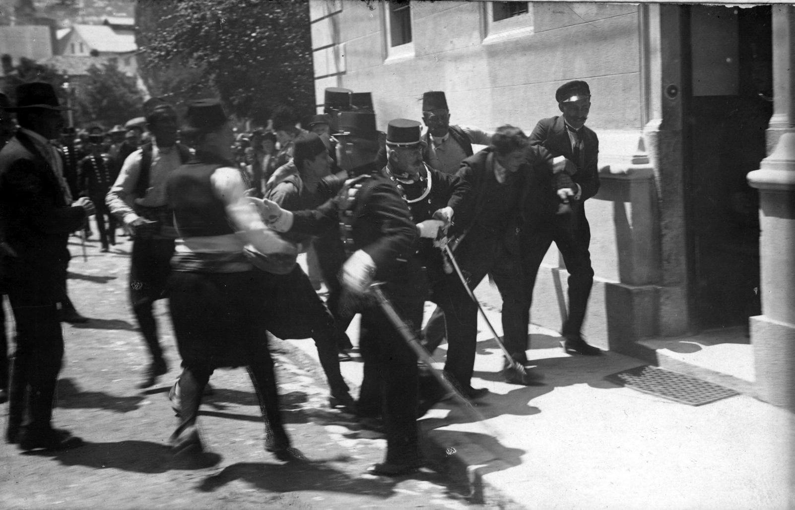 A man being seized and dragged away by police and soldiers in a Sarajevo street in 1914
