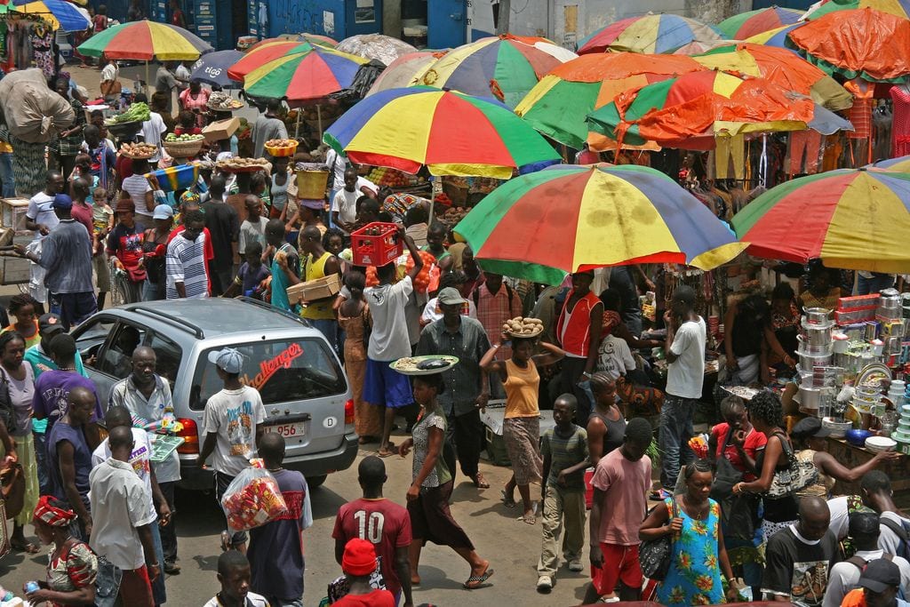 A busy market street with vendors and shoppers