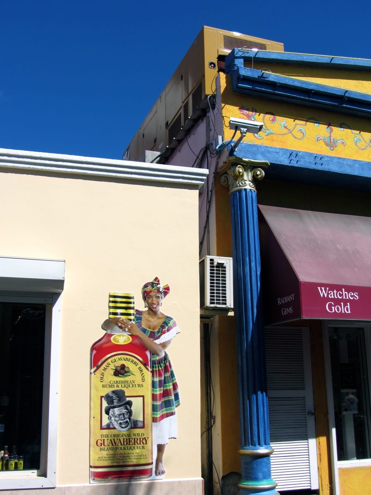 A mural advertisement for guavaberry liqueur painted on a building