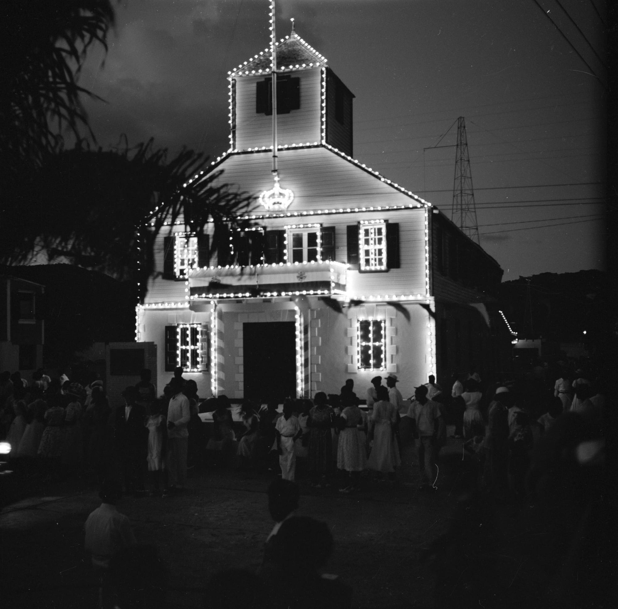 A colonial government building in Philipsburg lit up at night, mid-20th century