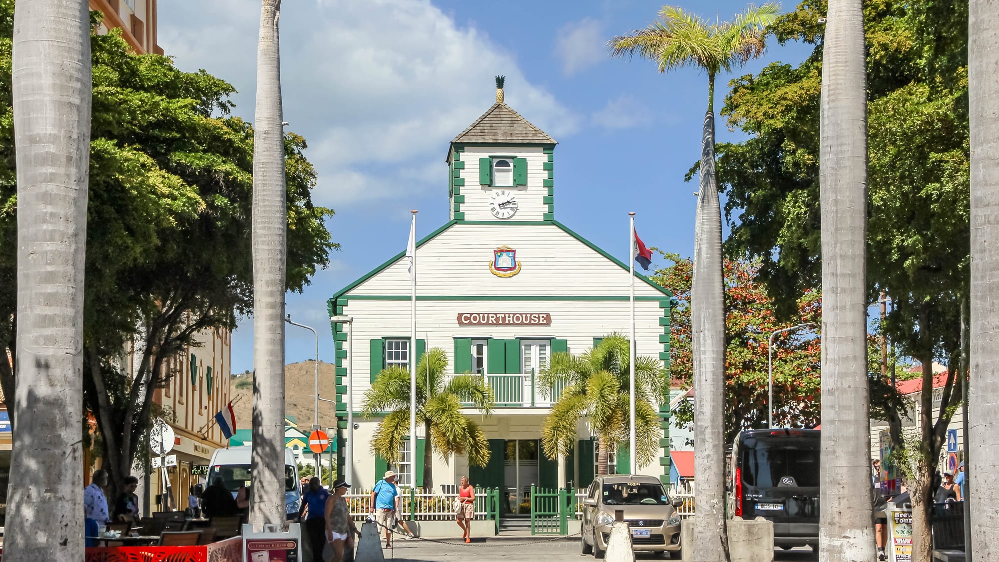The white colonial courthouse with a green cupola on a palm-lined square in Philipsburg, Sint Maarten