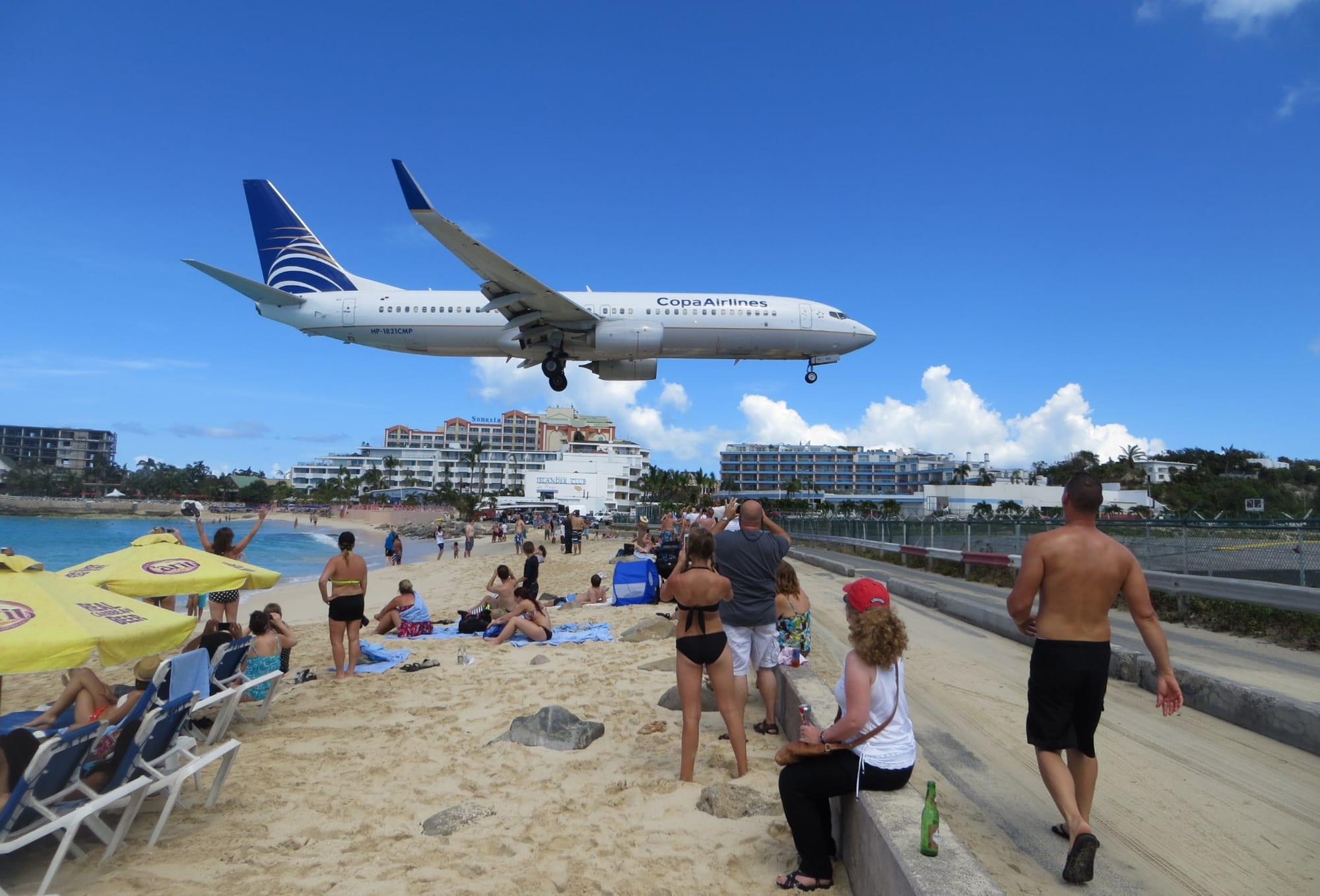 A passenger jet passing just metres above sunbathers on Maho Beach as it lands at Sint Maarten's airport