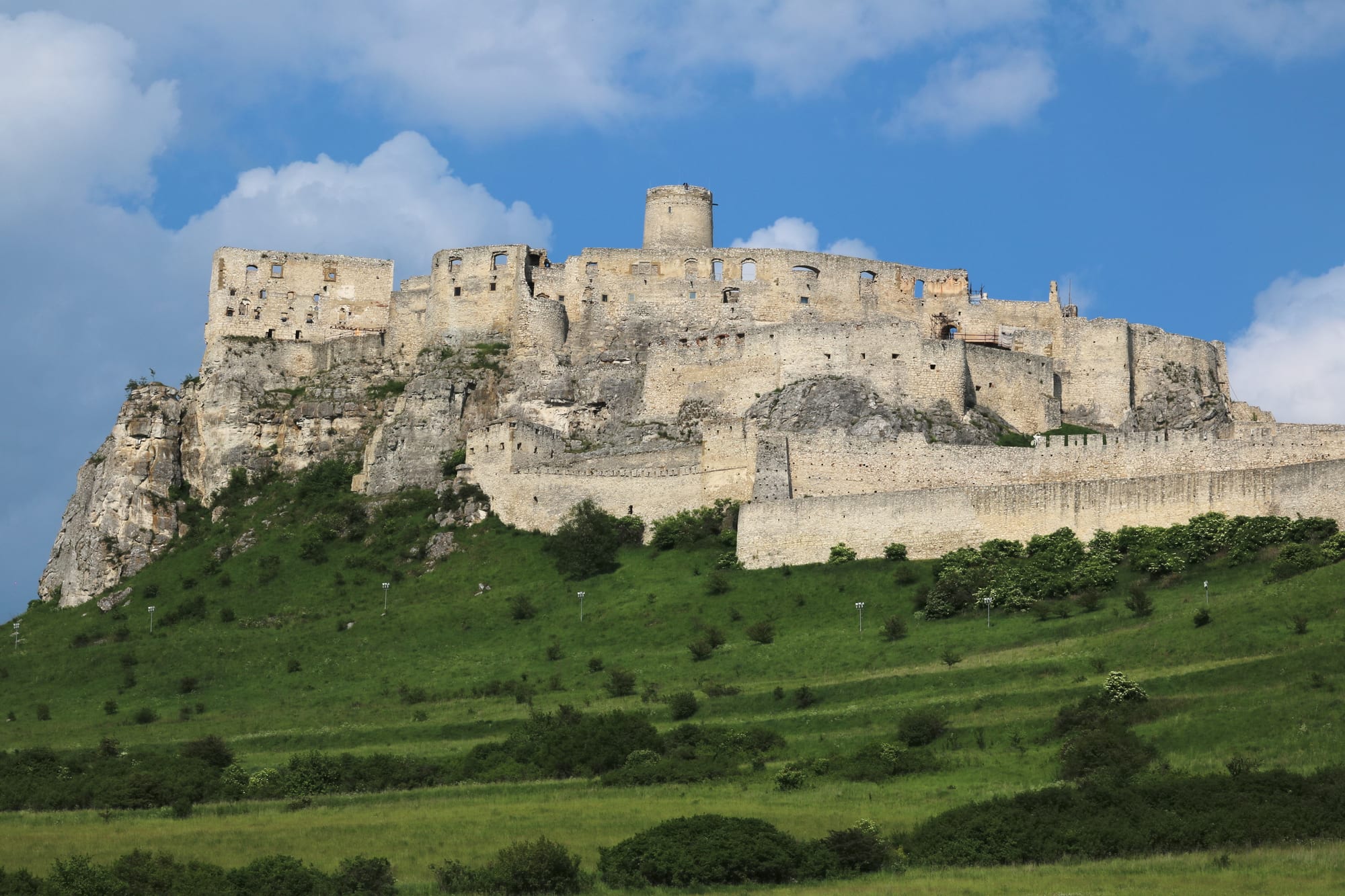 The extensive stone ruins of a hilltop castle complex