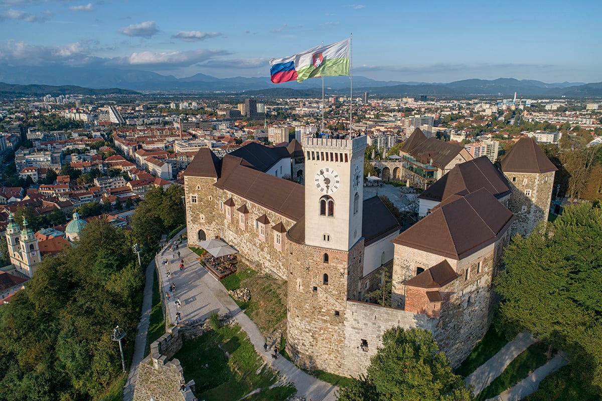 A hilltop medieval castle overlooking a city
