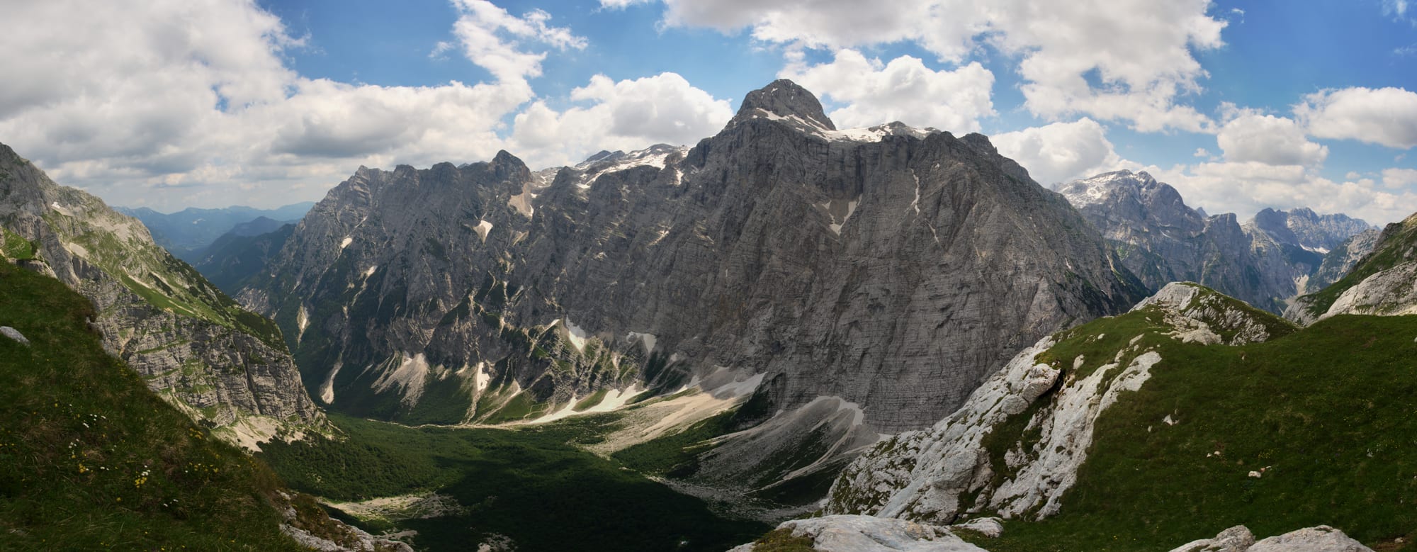 A dramatic mountain valley with a jagged peak at its head