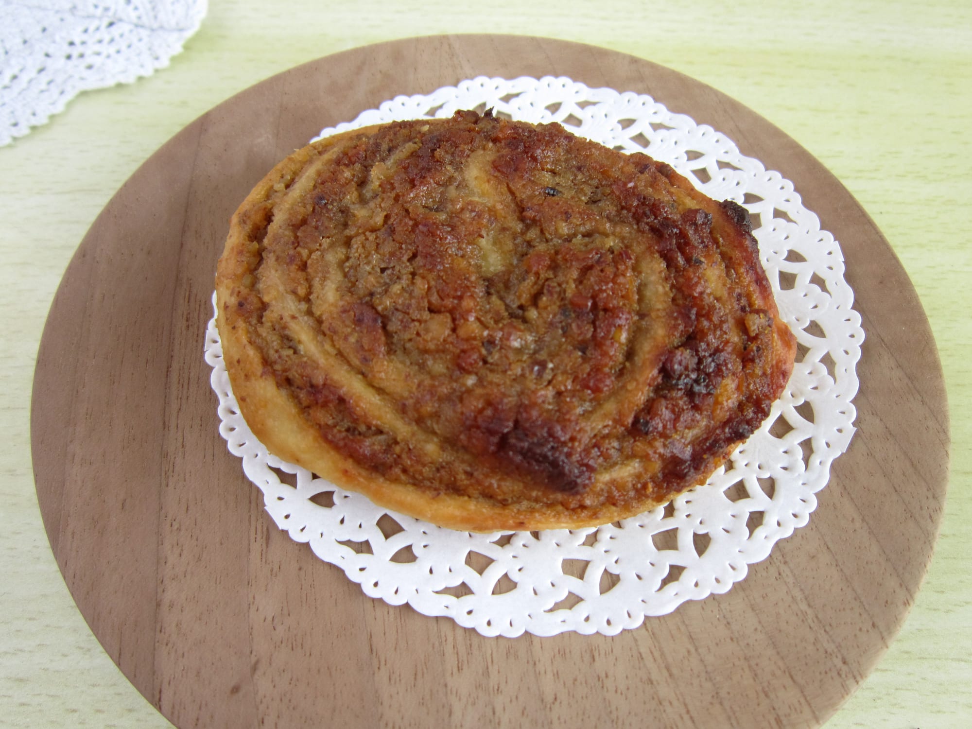 A rolled pastry with walnut filling, sliced to show its spiral pattern