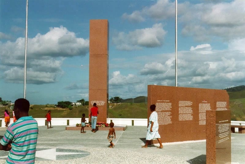 A war memorial monument on a hilltop overlooking the coast
