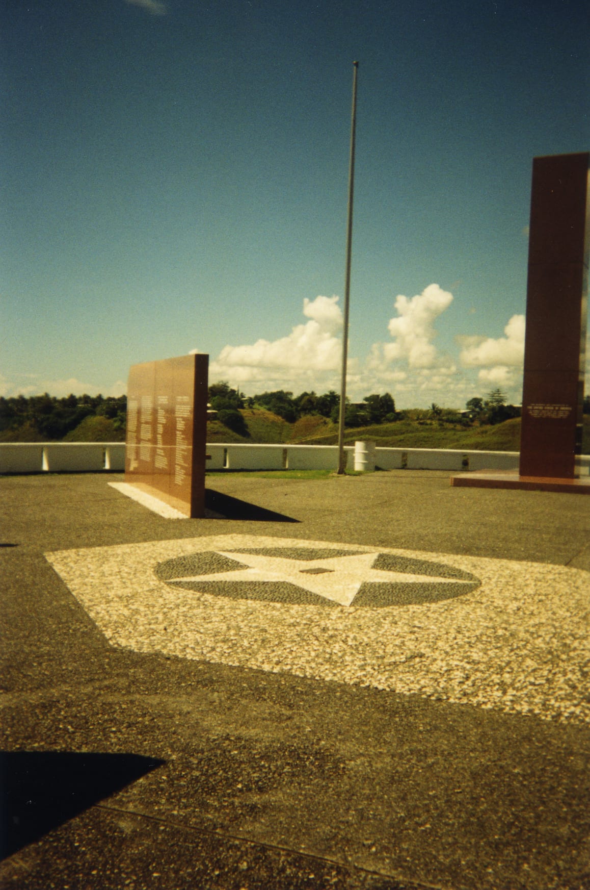 A war memorial with commemorative plaques overlooking the coastline