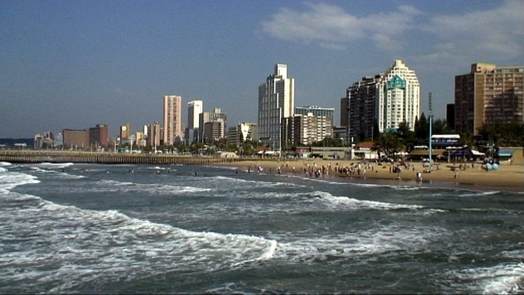 A beachfront promenade lined with palm trees and high-rise buildings