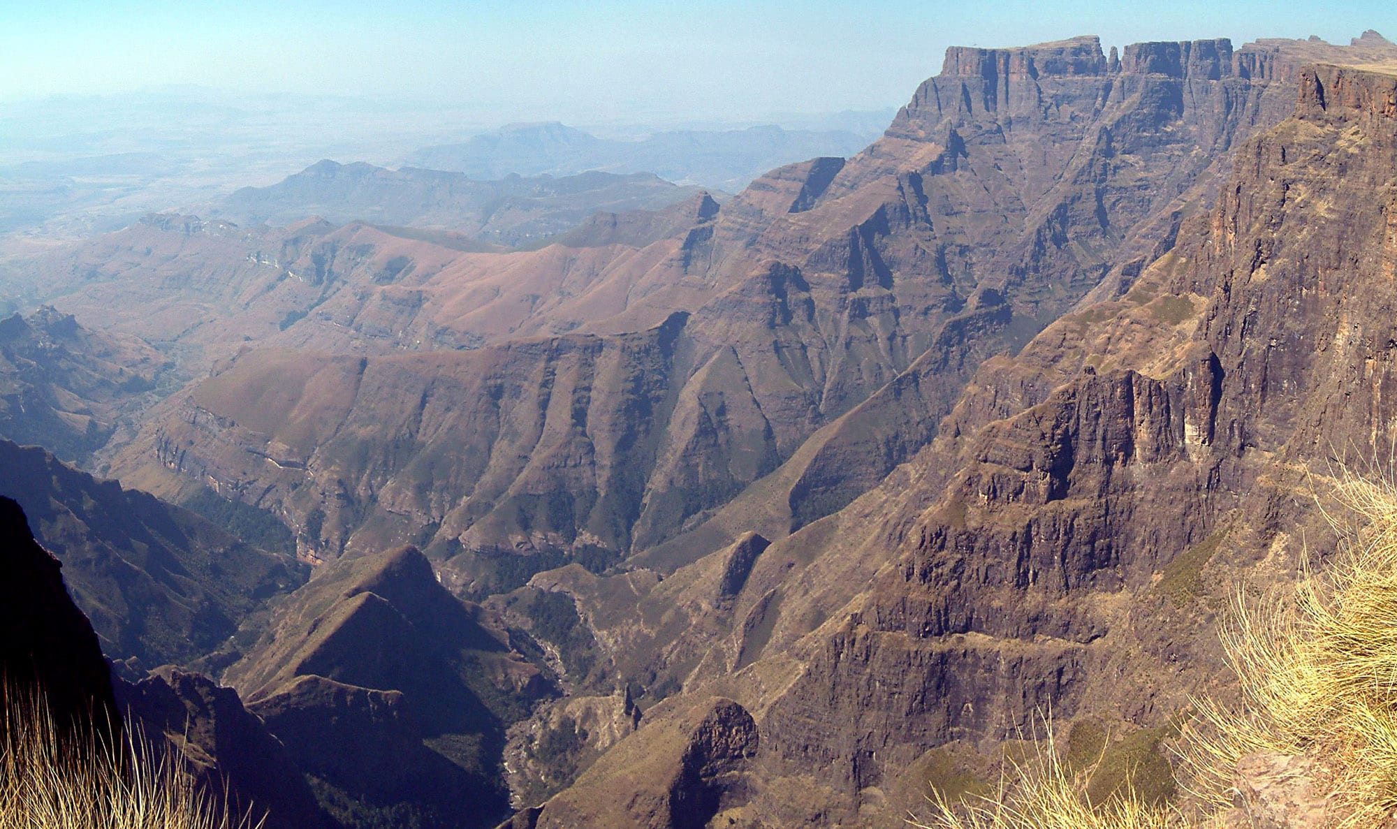 A dramatic view over a deep mountain amphitheatre with sheer cliffs and layered peaks