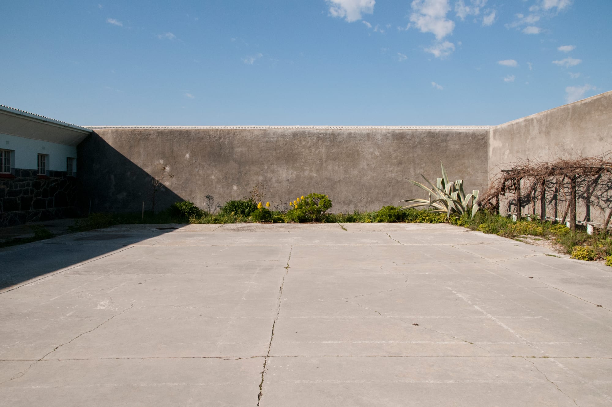 A prison courtyard with cell blocks visible