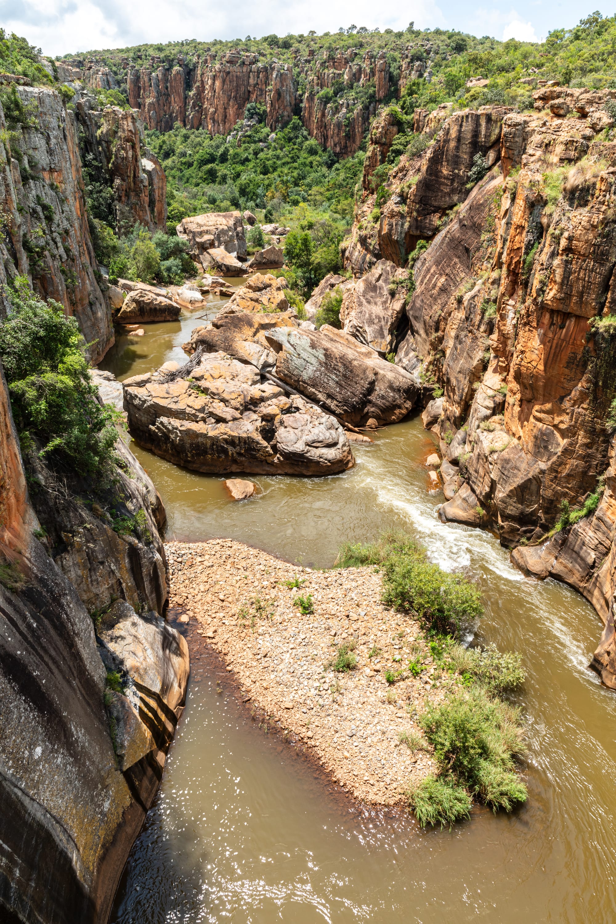 A vast, deep river canyon with lush green forested walls