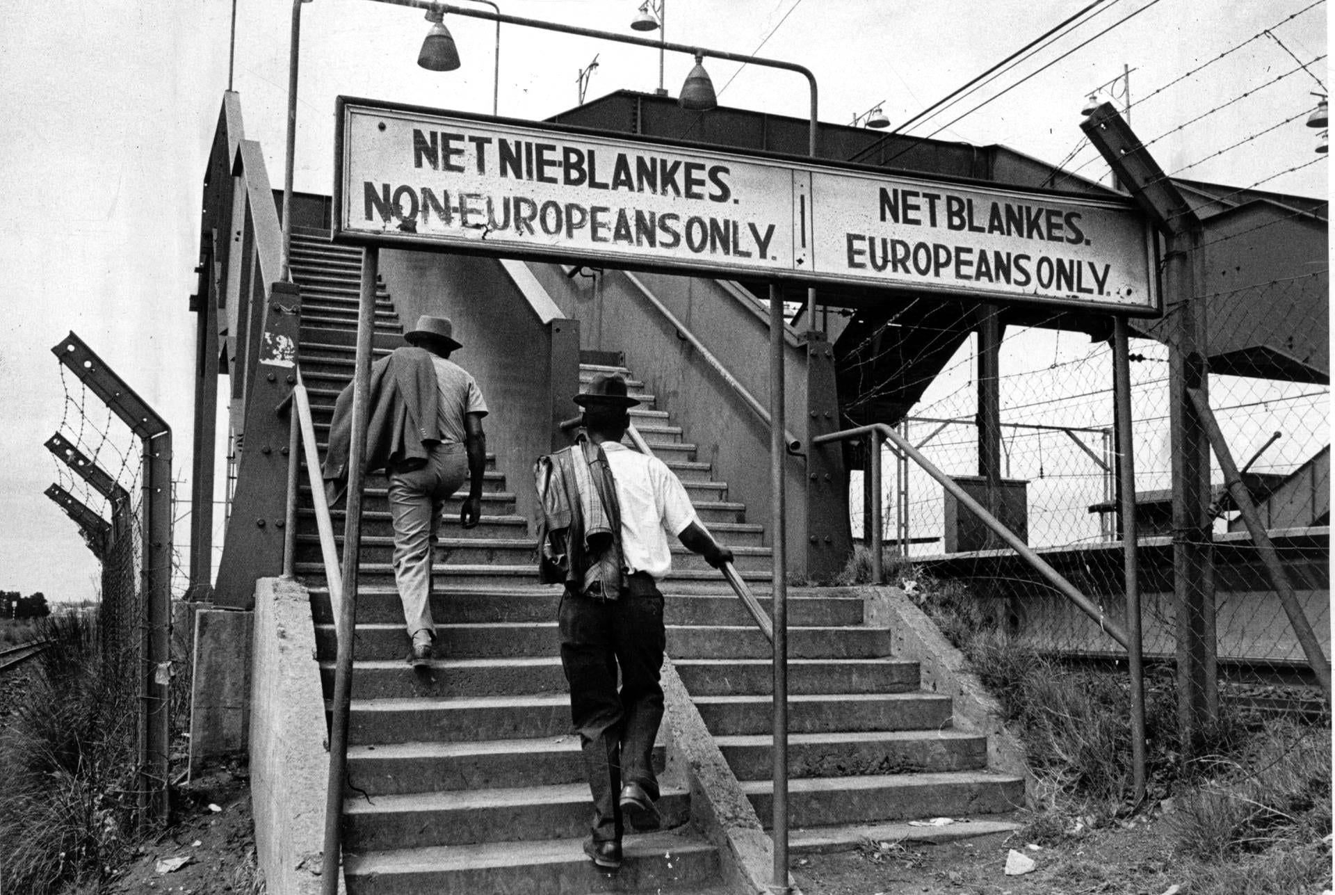 A South African railway platform sign reading 'Europeans Only' in English and Afrikaans