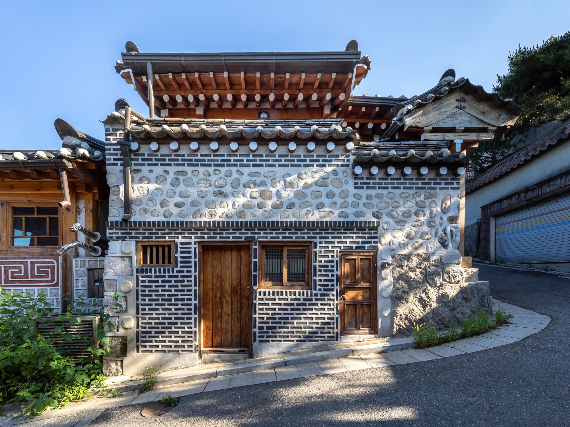 Traditional wooden Korean houses along a steep hillside street