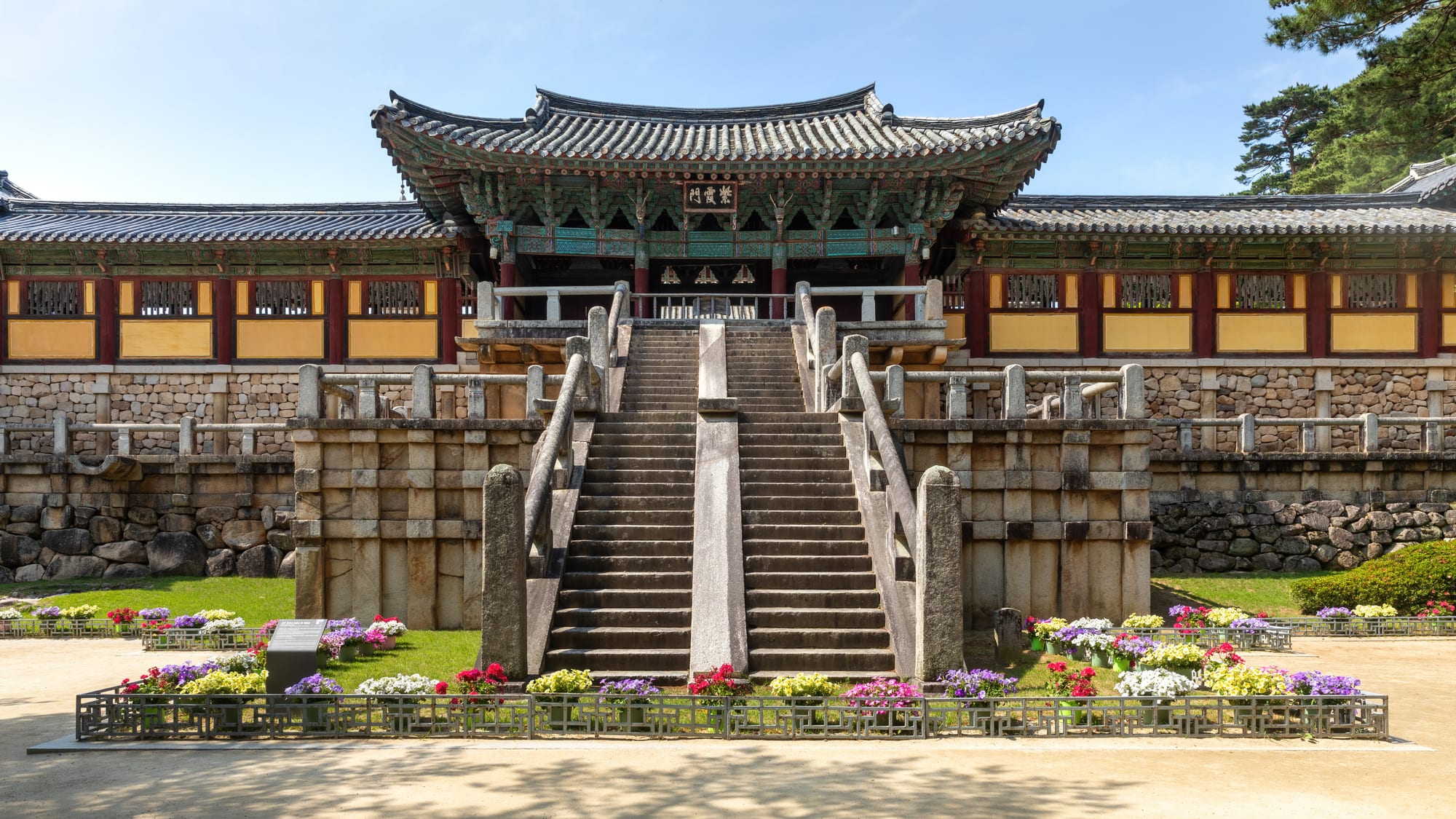 A stone staircase leading up to a traditional Buddhist temple gate