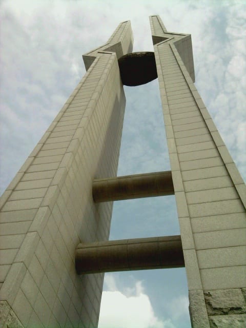 A tall pair of curved white memorial columns at the May 18th National Cemetery in Gwangju
