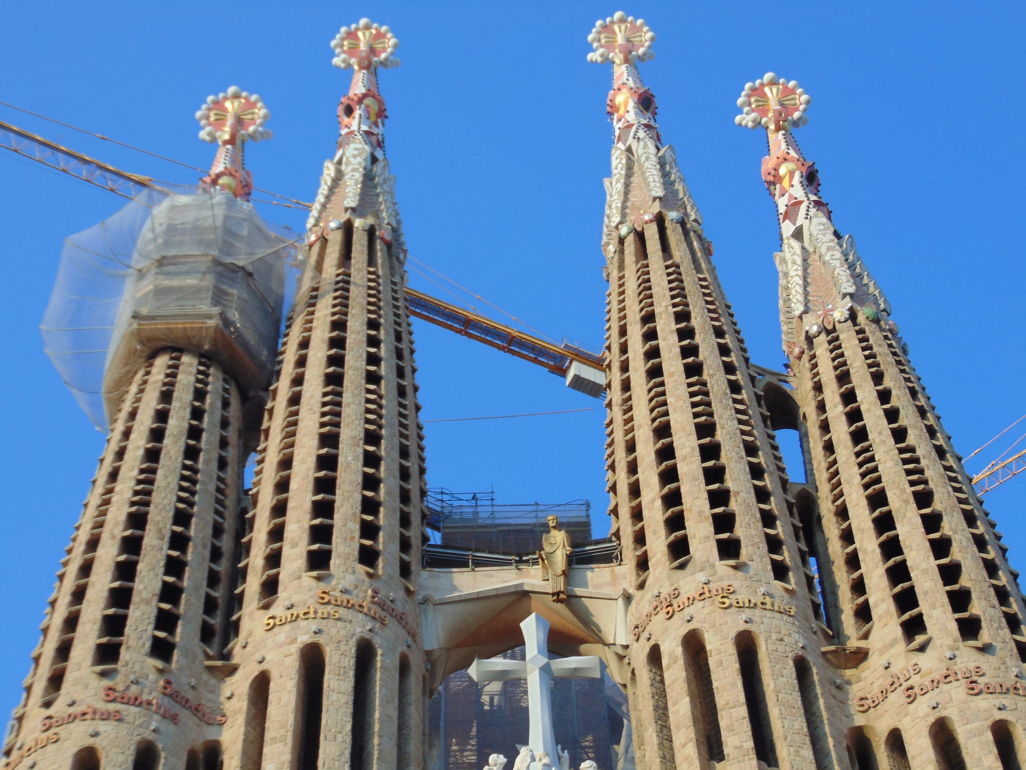 Towering ornate stone spires of an unfinished cathedral