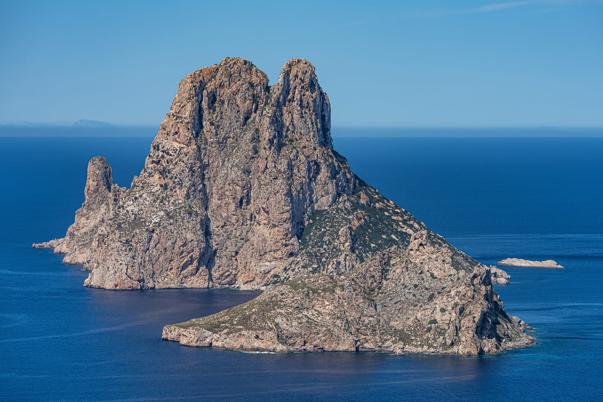 A dramatic rocky islet rising steeply from the sea
