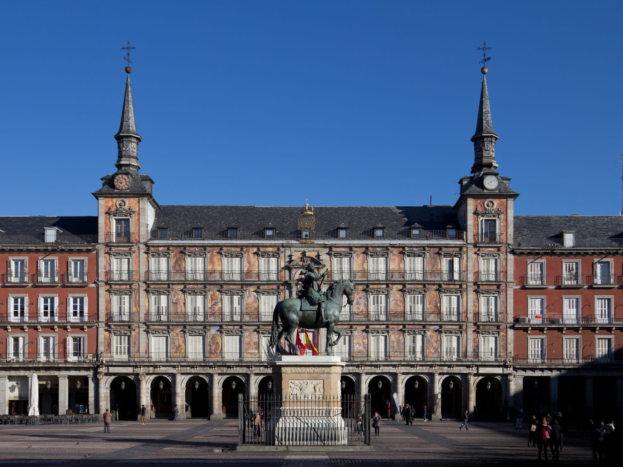 A grand historic square surrounded by uniform arcaded buildings
