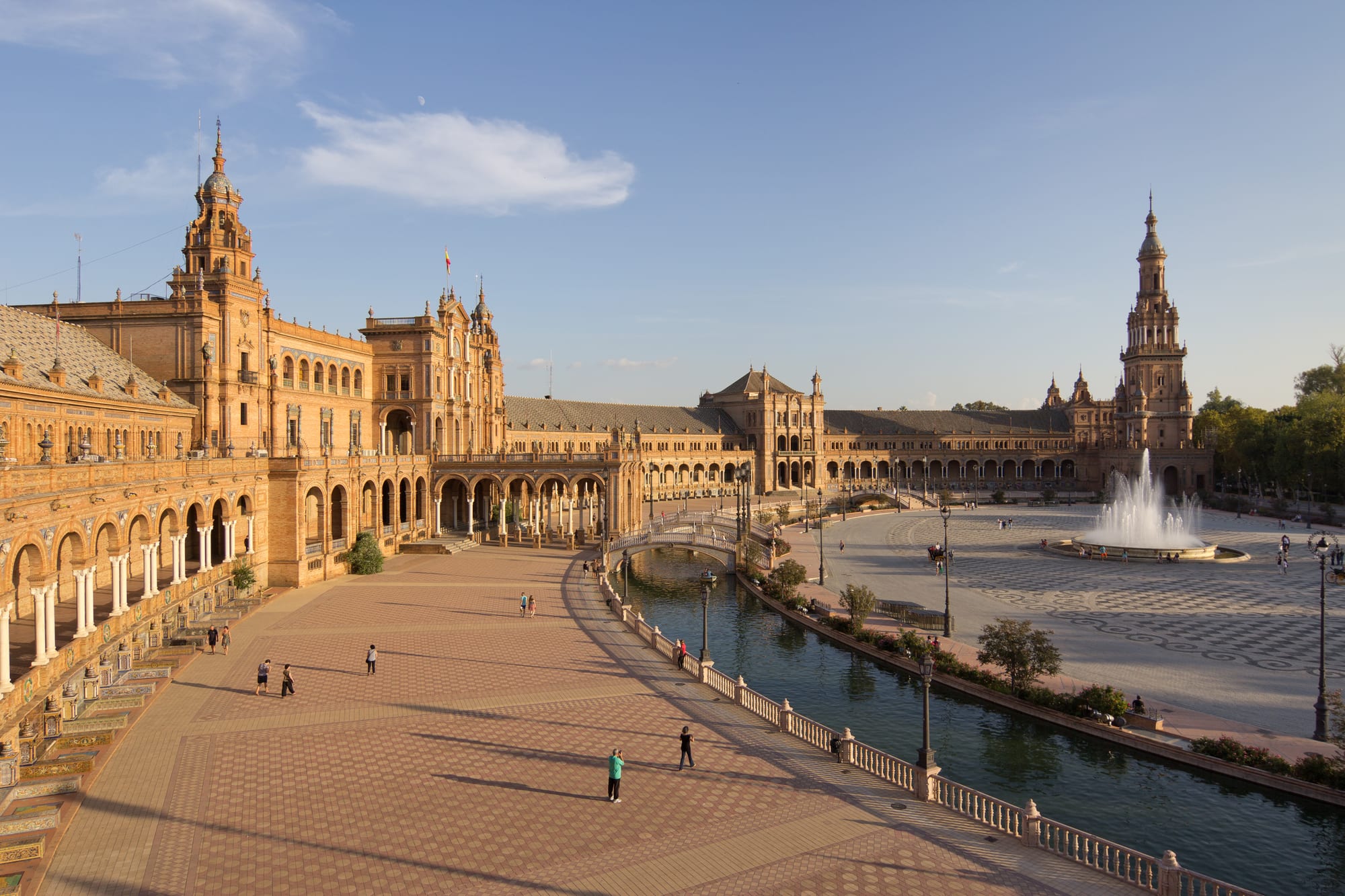A grand semicircular plaza with a canal, bridges, and ornate tiled alcoves