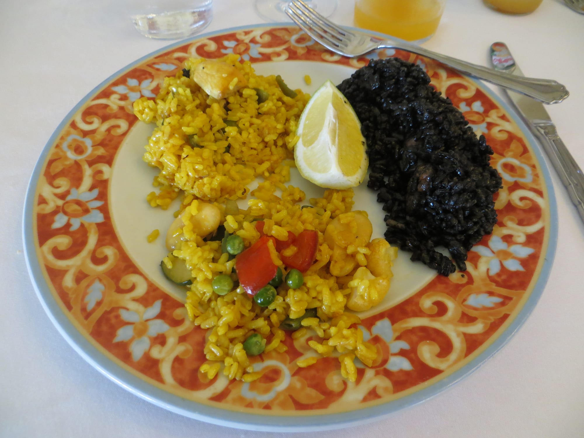 Different types of saffron rice dishes served in wide pans