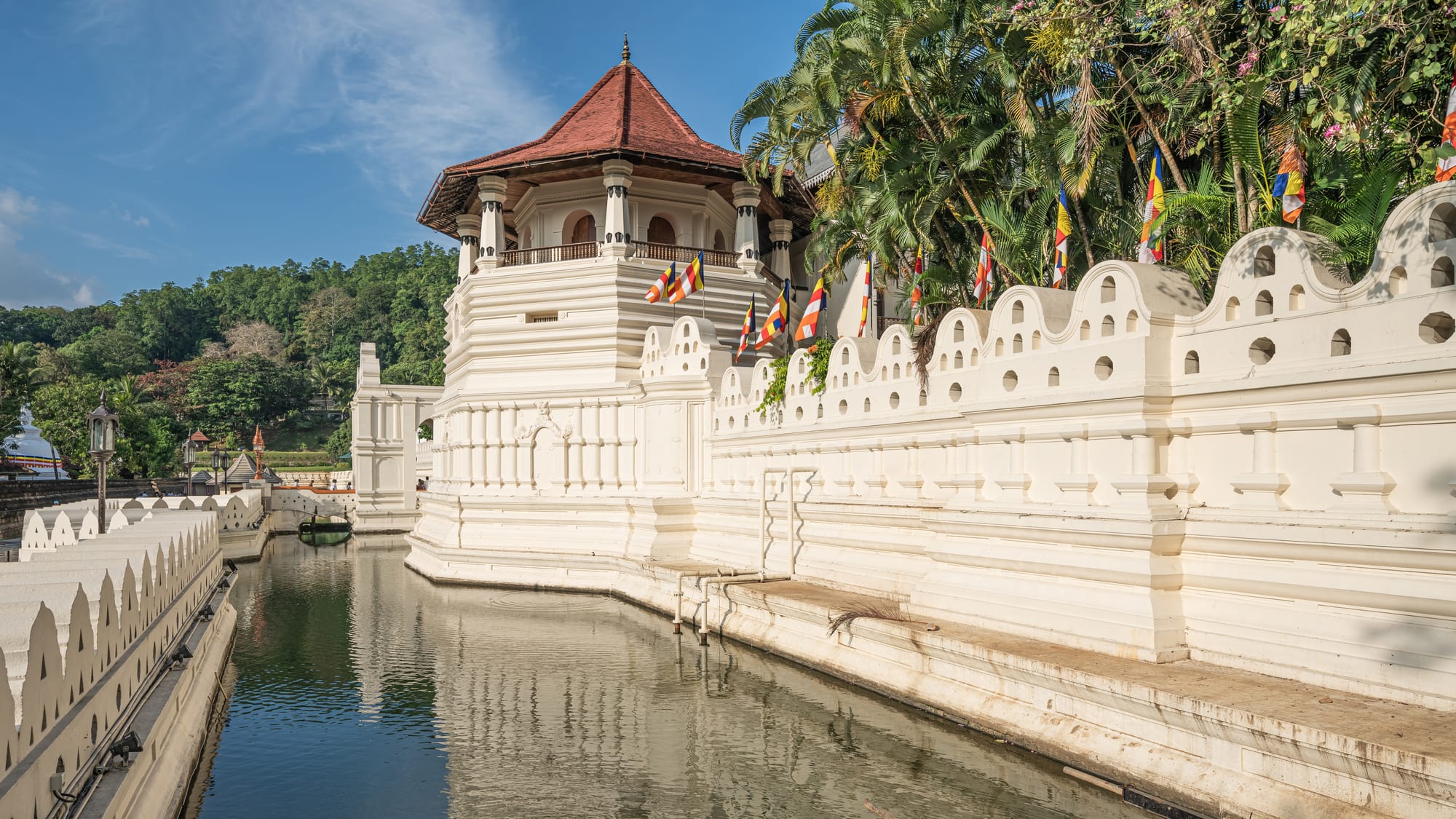 An ornate Buddhist temple complex beside a lake
