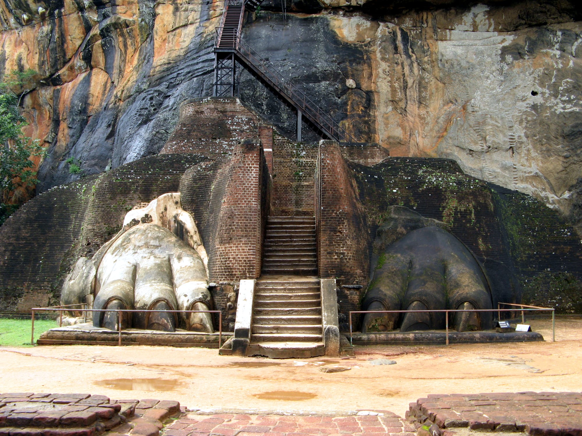 Ancient stone stairways and ruins climbing a massive rock outcrop