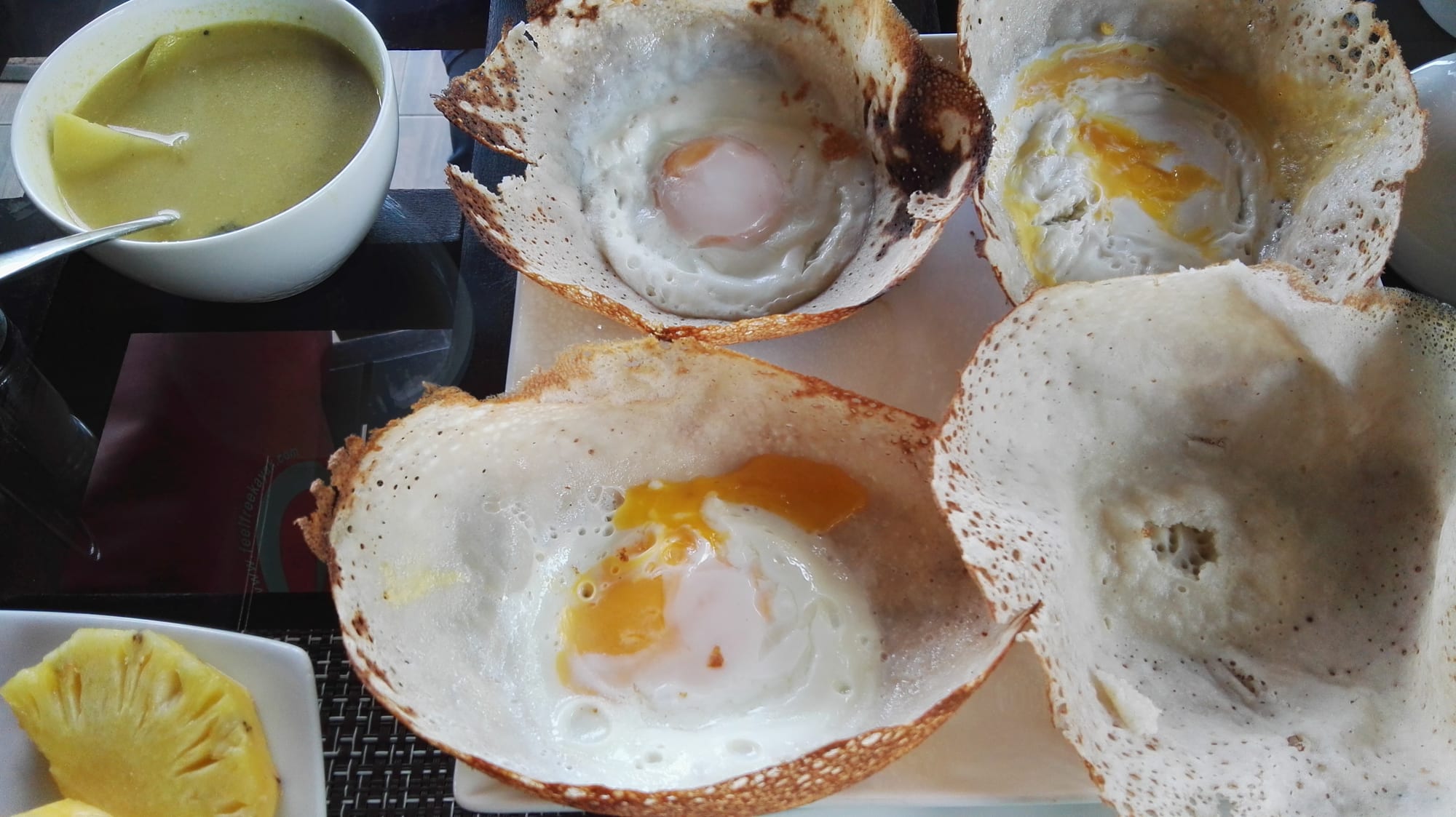 A bowl-shaped pancake with a fried egg in the centre