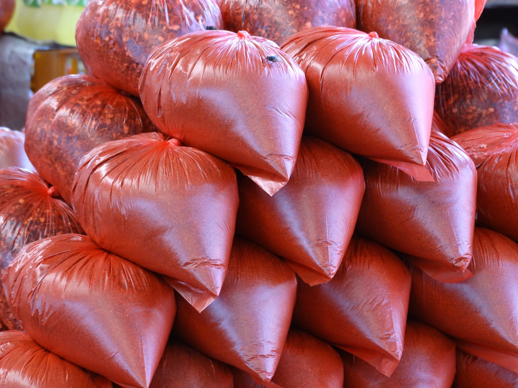 Bags of colourful spices displayed at a market