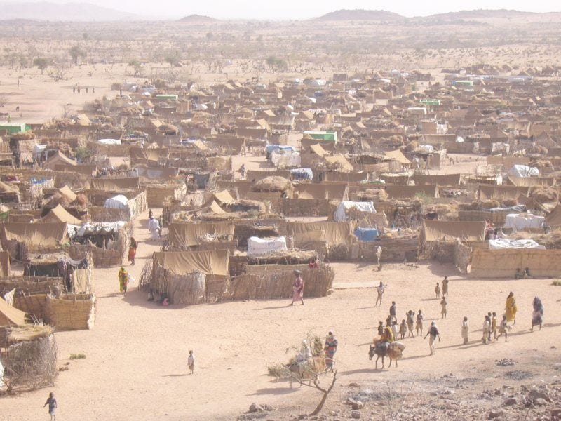 Rows of makeshift shelters and tents in a dusty Darfur refugee camp across the border in Chad
