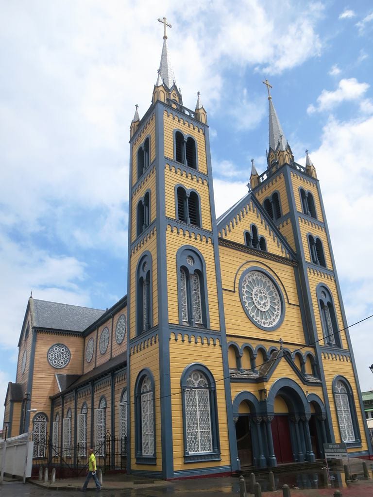 A large wooden cathedral with twin spires