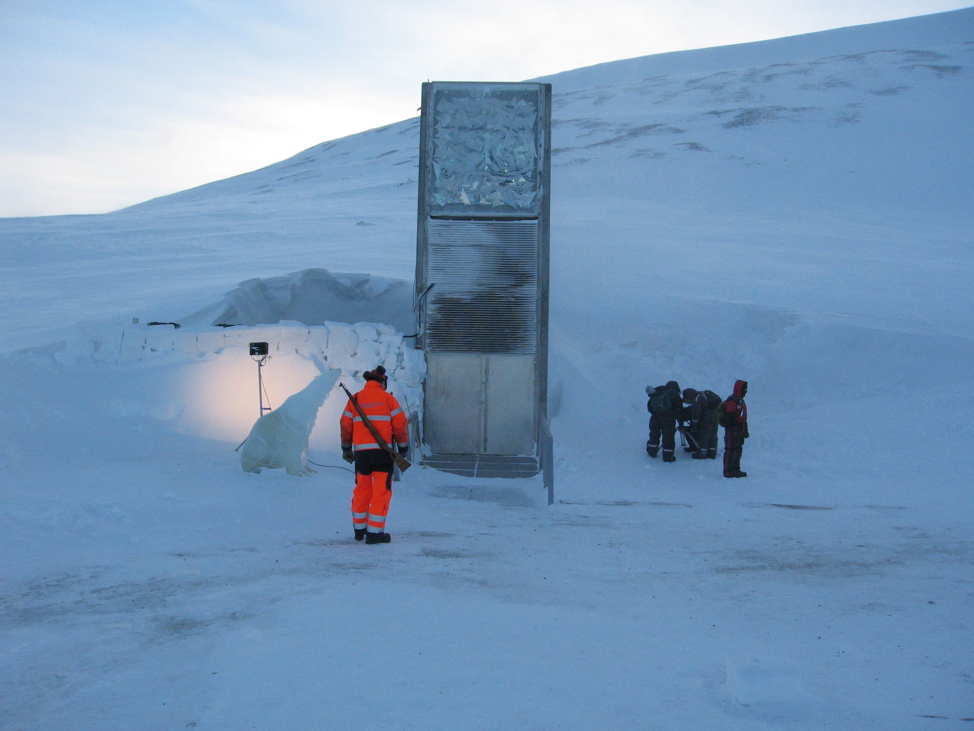 A concrete entrance structure built into a snowy mountainside