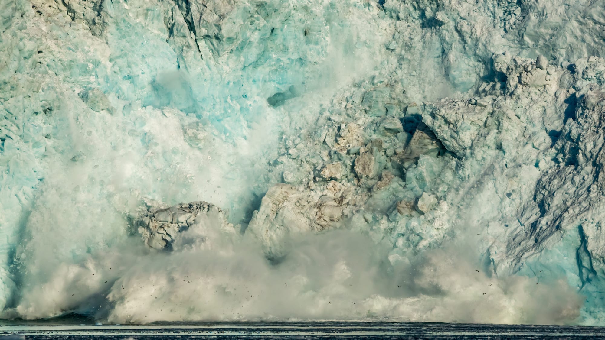 A large glacier calving ice into the sea