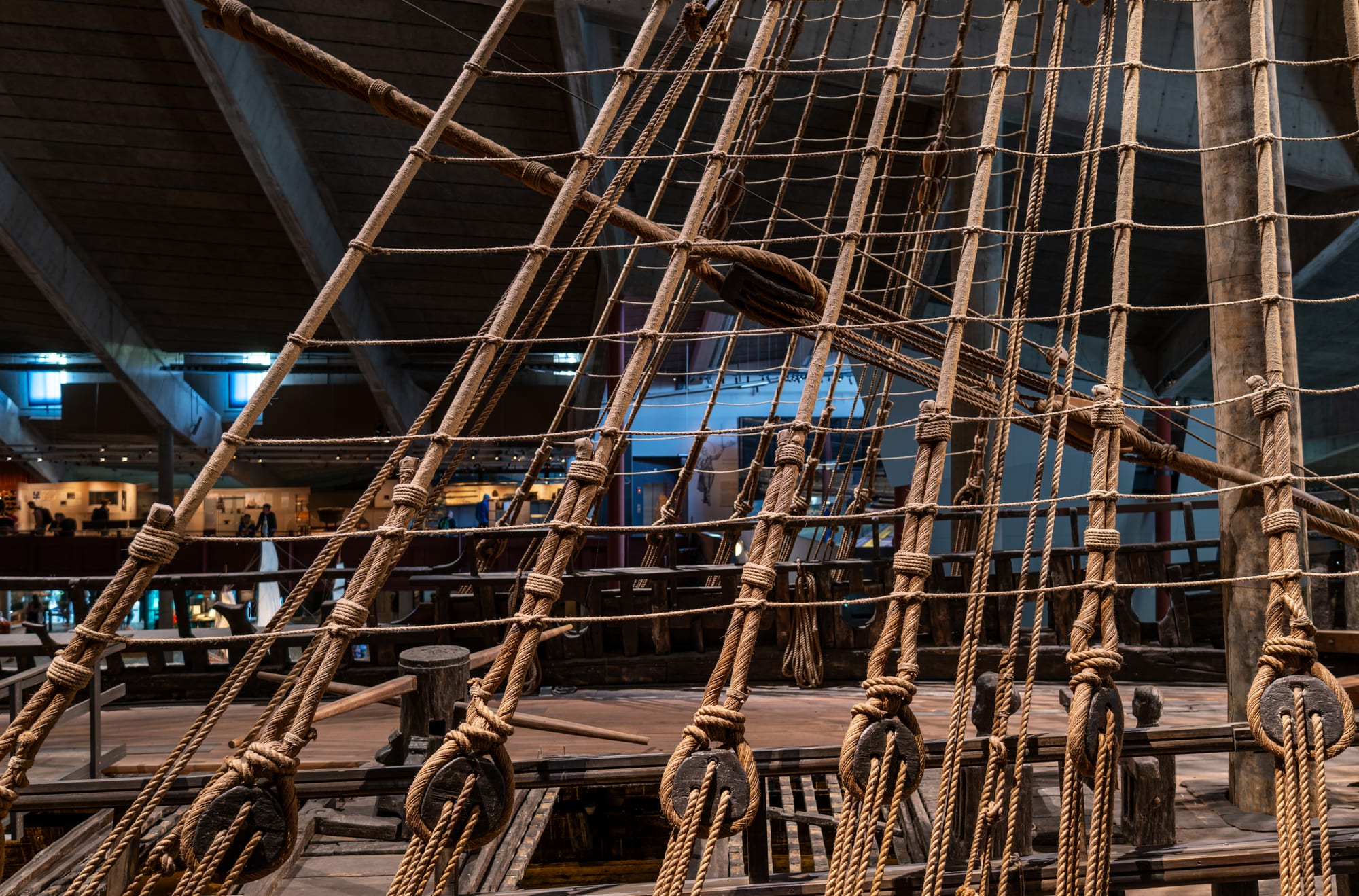 A massive, ornately carved wooden warship displayed inside a museum