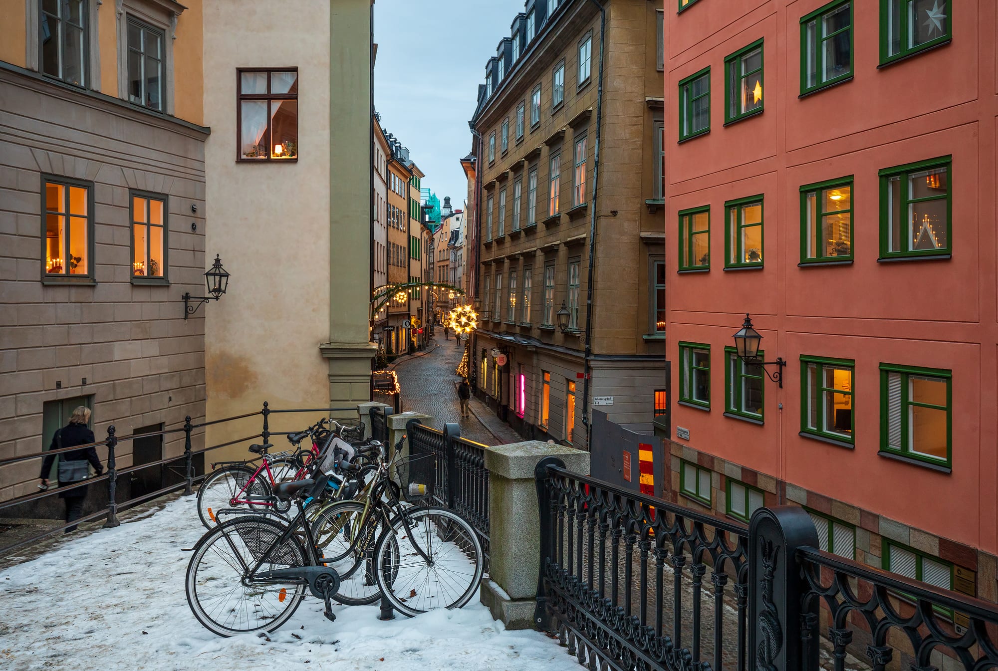A narrow cobbled street lined with colourful old buildings in a historic old town