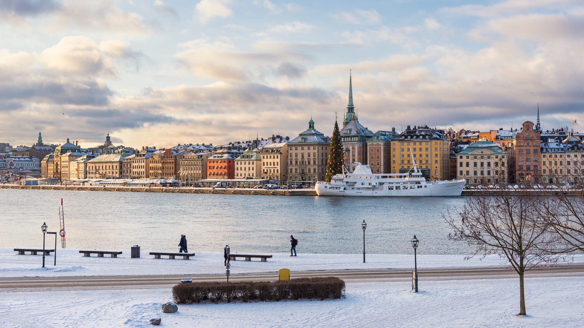 A row of colourful historic buildings along a waterfront in an old town