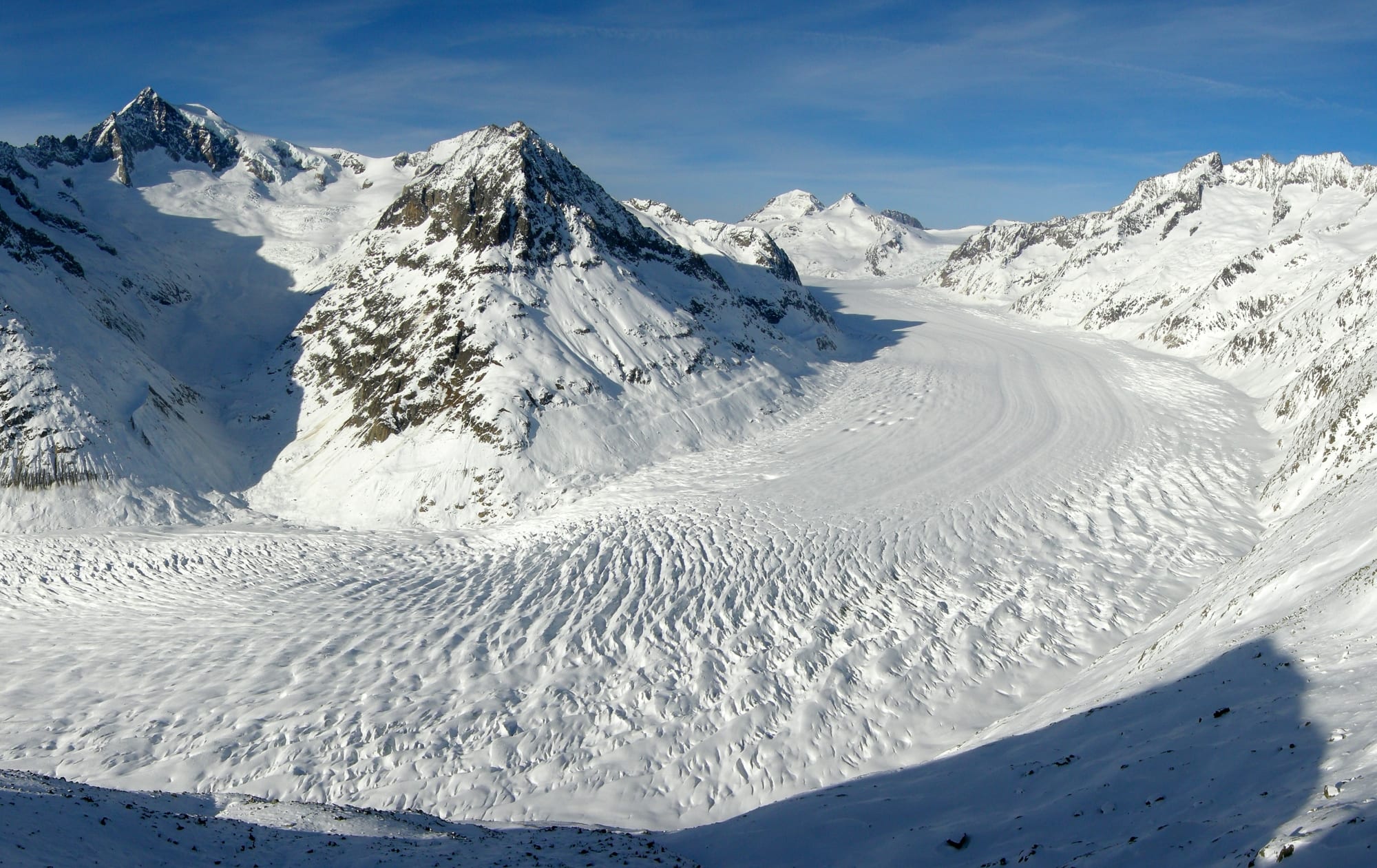 A vast river of ice winding between snow-covered mountain peaks