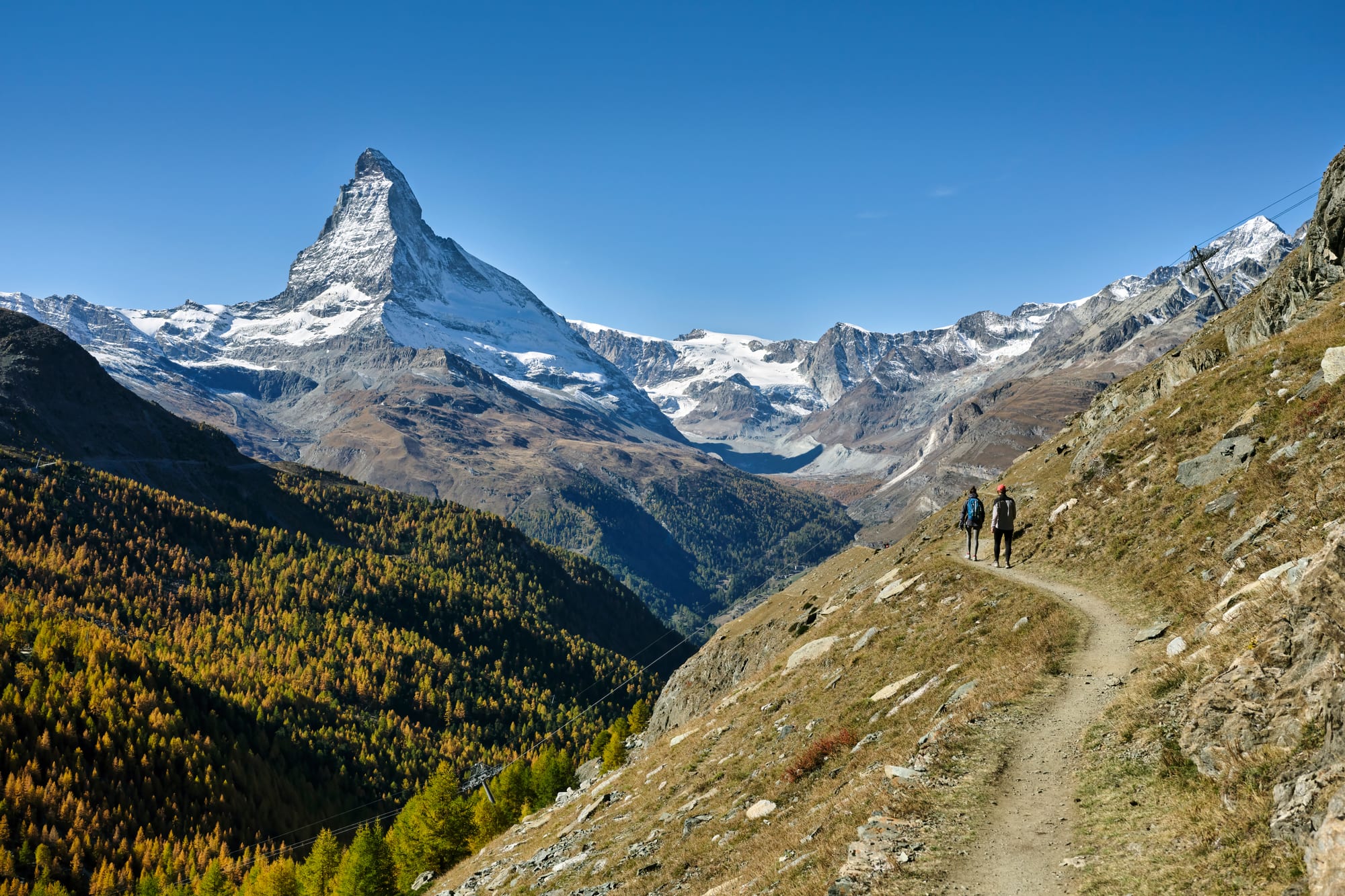 A dramatic pyramid-shaped snow-covered mountain peak