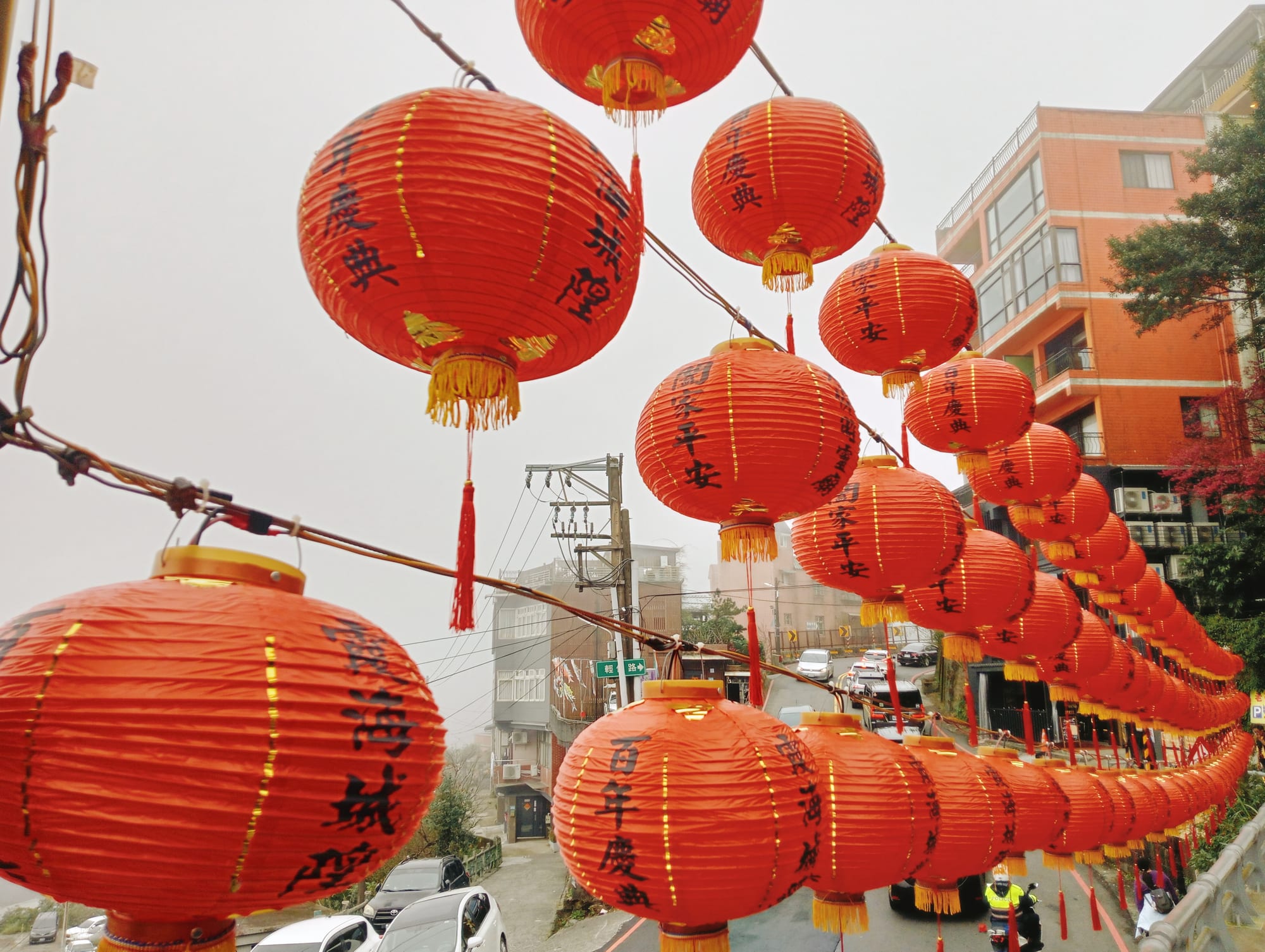 Traditional red lanterns hanging outside a temple entrance