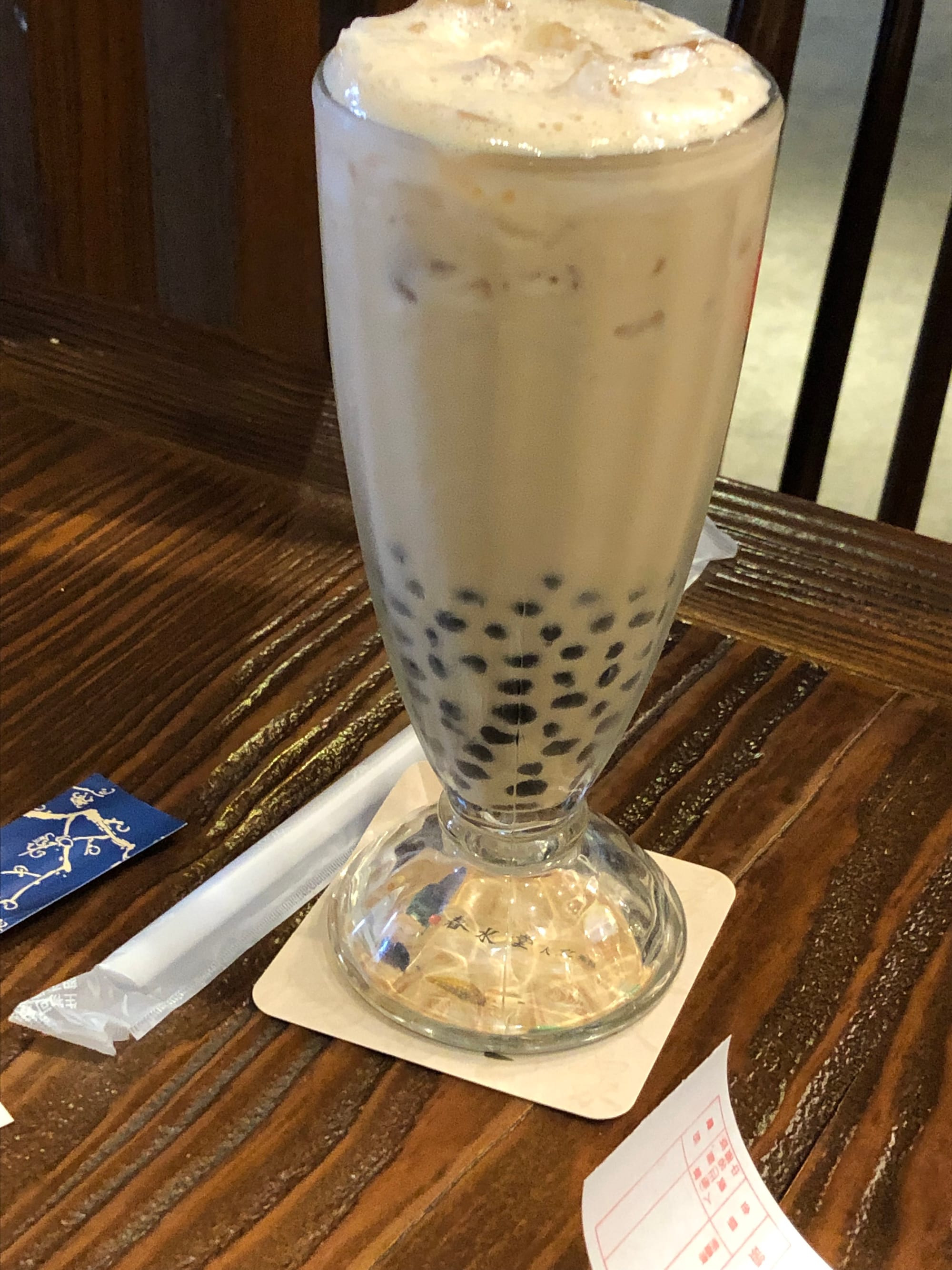 A cup of iced milk tea with tapioca pearls