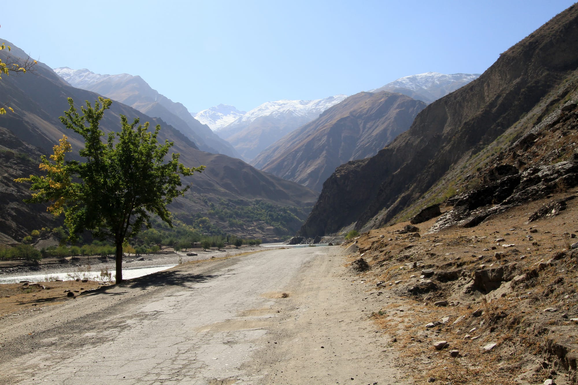 A remote mountain road winding through a high-altitude desert landscape