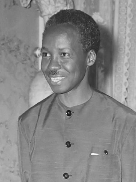 A portrait of Julius Nyerere in 1965, wearing a light suit