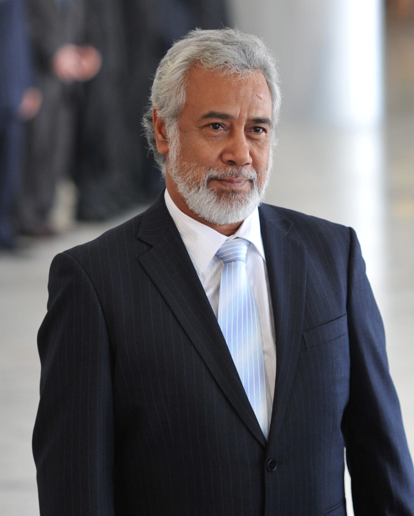 A portrait of Xanana Gusmão with grey hair and beard, in a dark jacket, 2011