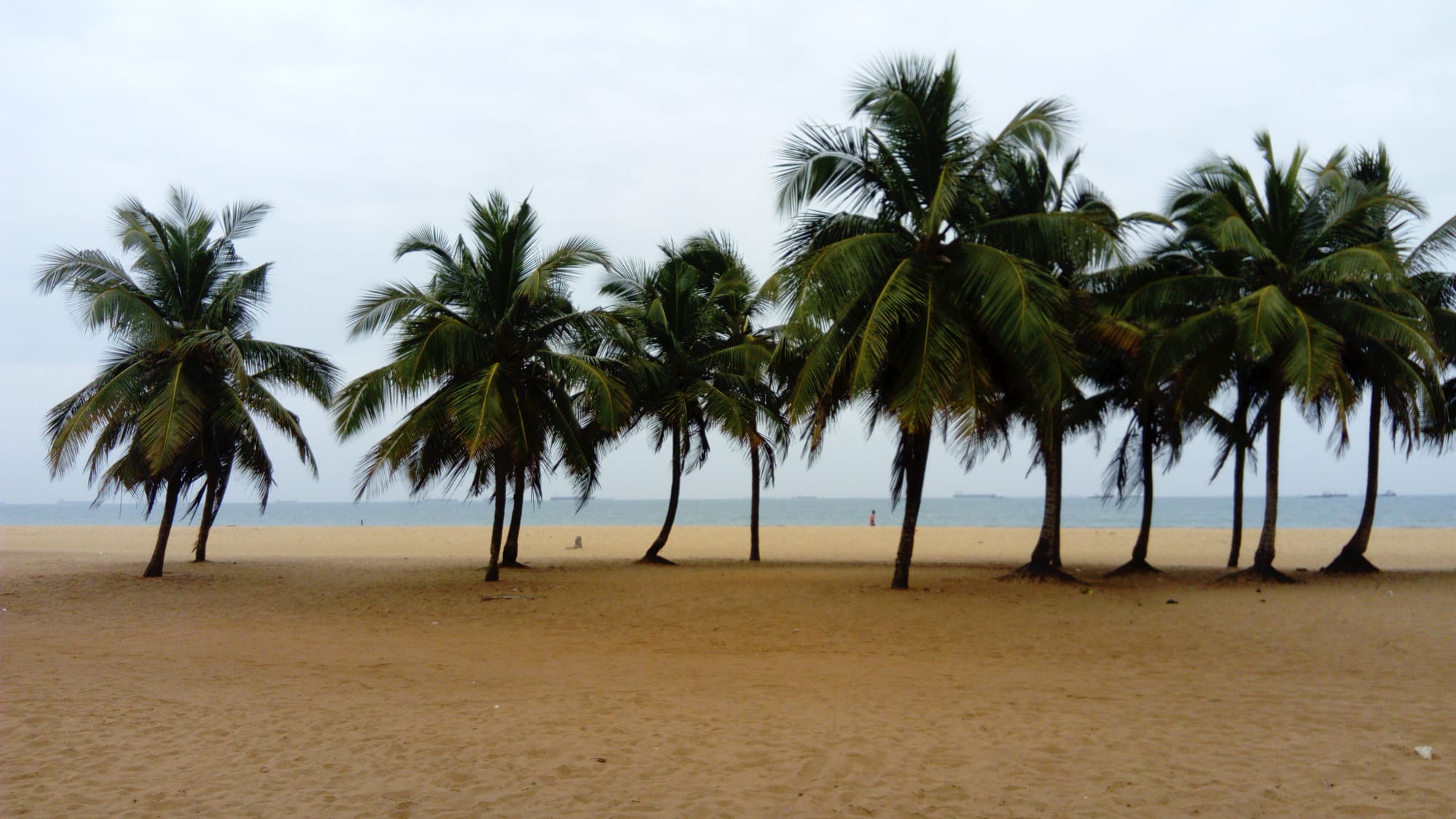 A wide sandy beach along the Gulf of Guinea coastline
