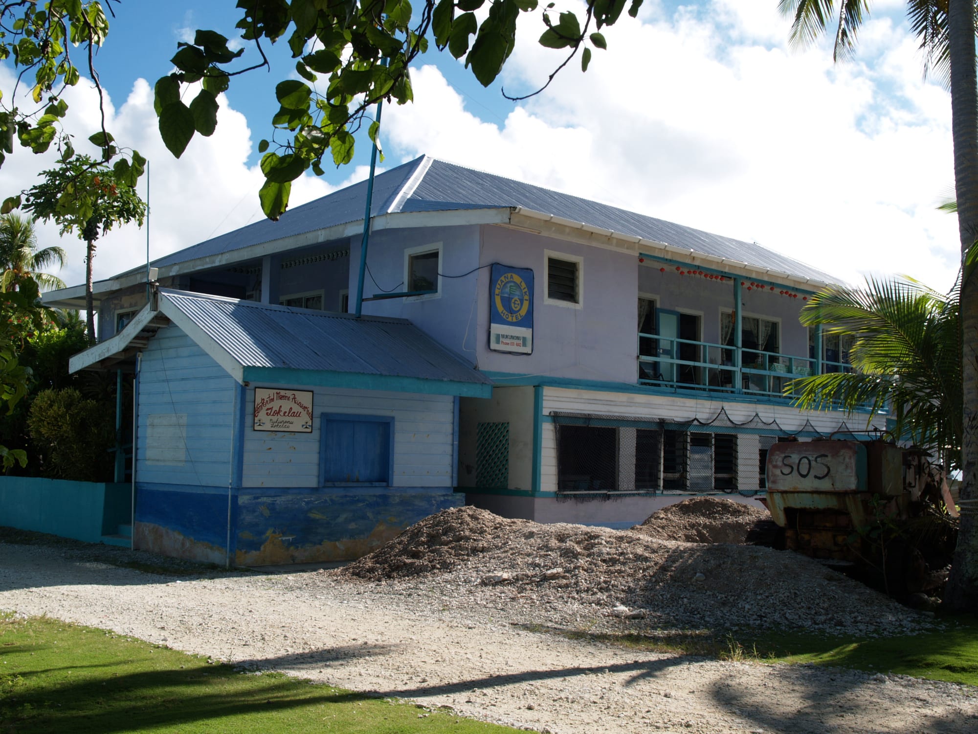 A simple guesthouse building on a small coral island