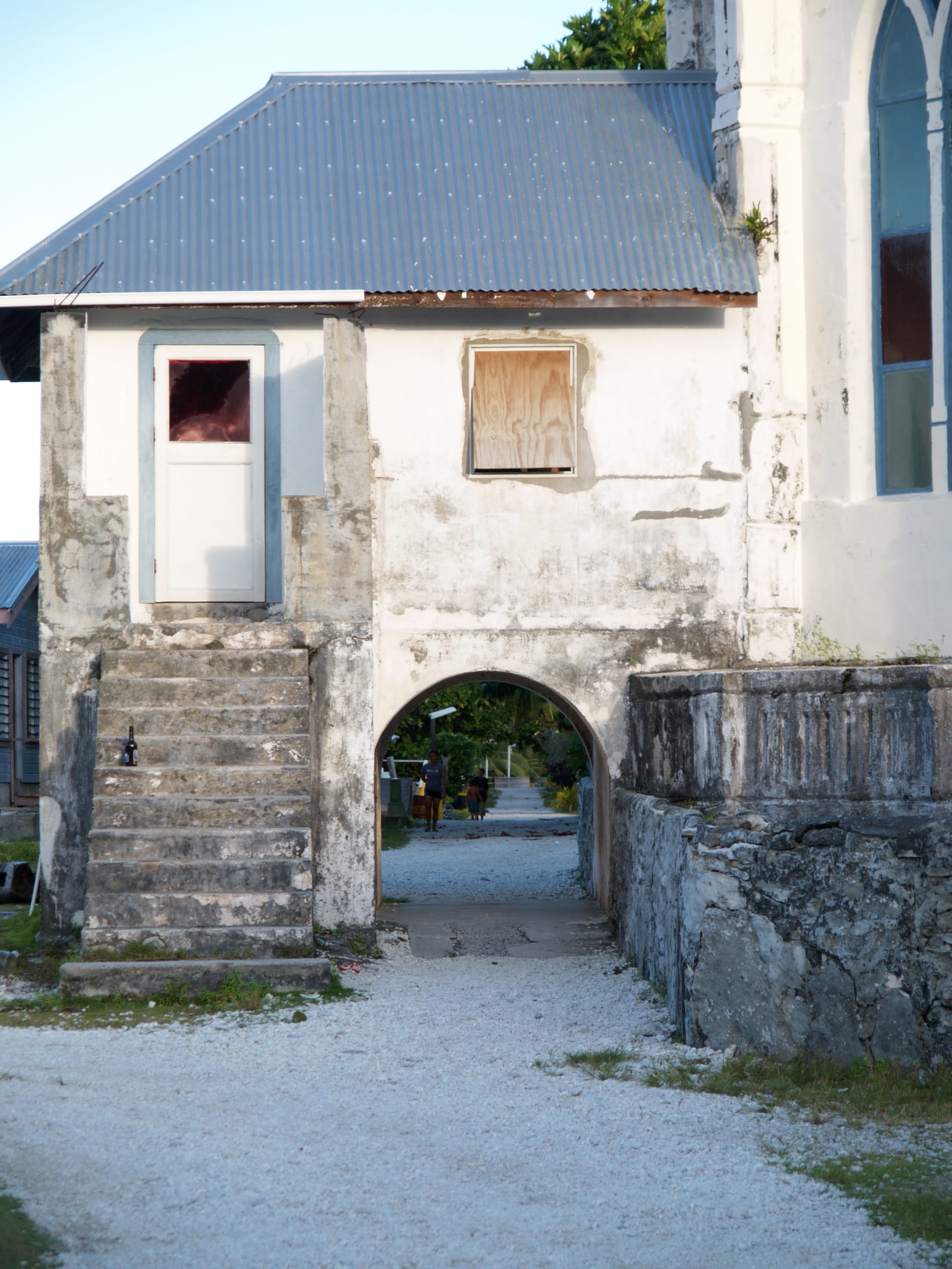 A simple whitewashed church on a small coral island